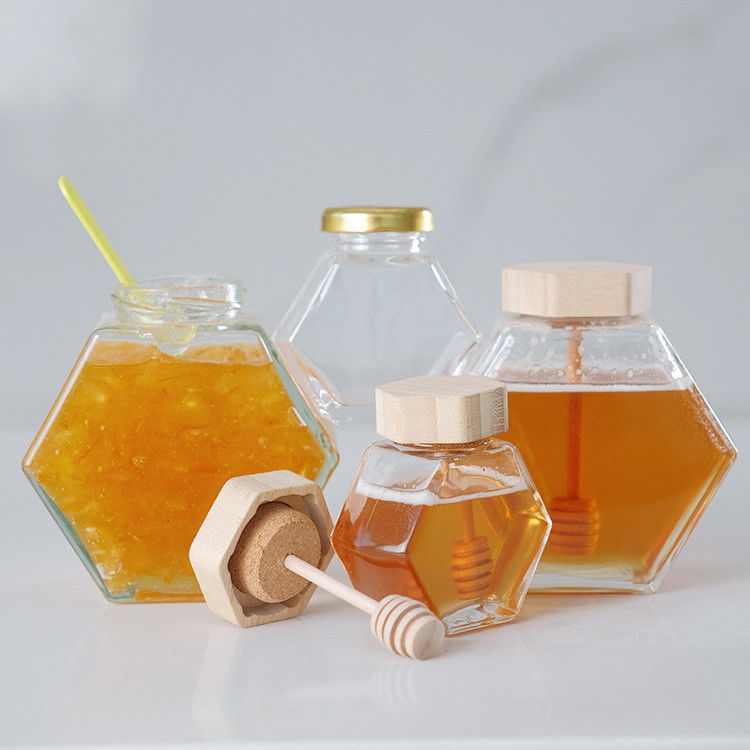 Hexágono espesado Transparente Almacenamiento de alimentos de diferentes tamaños Jarrones de vidrio de miel con tapas de metal selladas