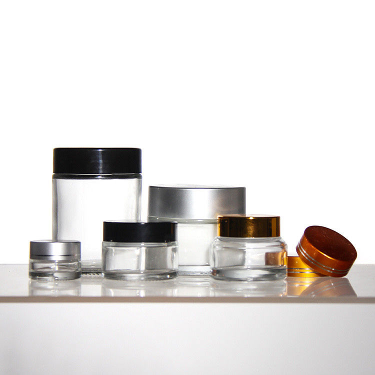 Cosméticos de colores de ODM Jarrones de vidrio de crema con tapa de acacia dorada