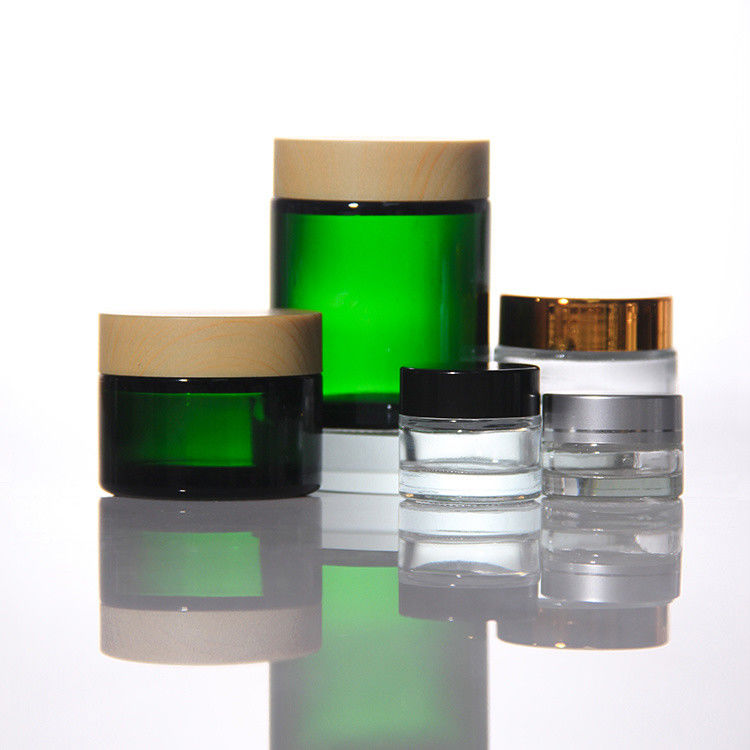 Cosméticos de colores de ODM Jarrones de vidrio de crema con tapa de acacia dorada