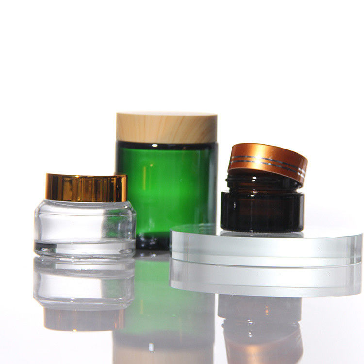 Cosméticos de colores de ODM Jarrones de vidrio de crema con tapa de acacia dorada