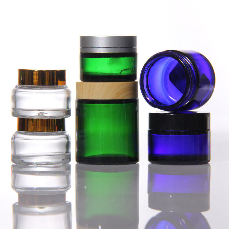 Cosméticos de colores de ODM Jarrones de vidrio de crema con tapa de acacia dorada