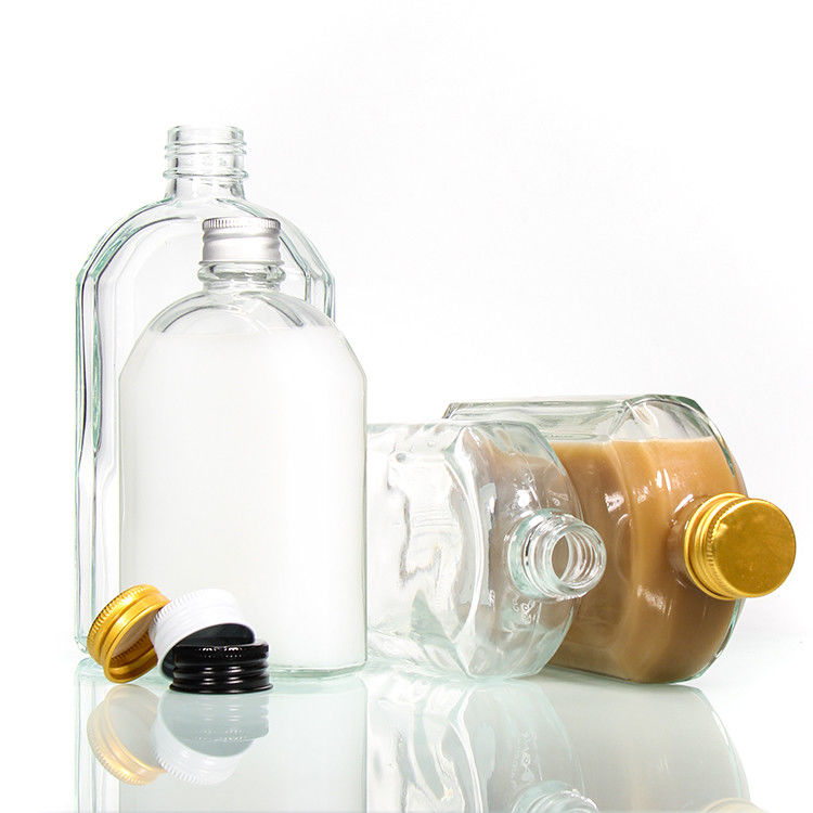 Botella plana de vidrio de licor transparente con tapa de aluminio