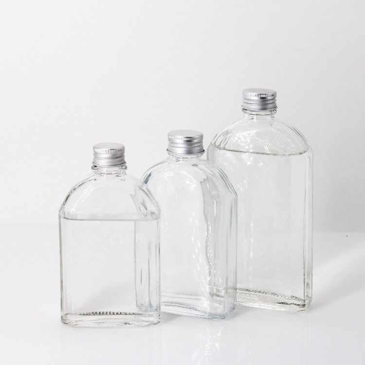 Nuevo diseño botella de vidrio de licor transparente de 200 ml 250 ml 300 ml con tapa de tornillo