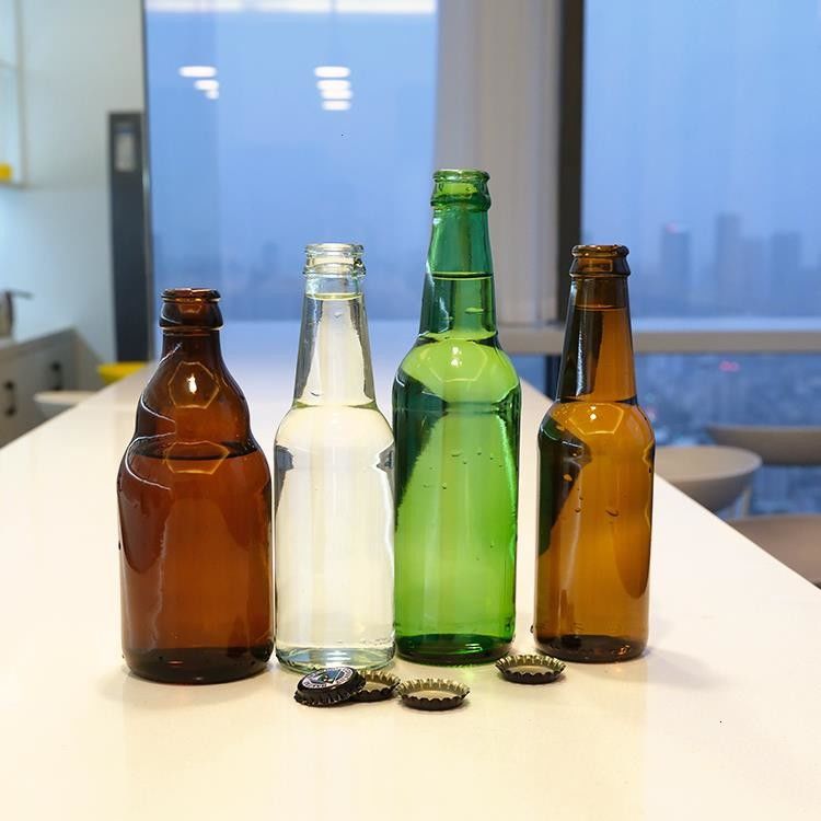 Bebida de cerveza de color ámbar verde de alta calidad botella de vidrio con estampado caliente para cerveza