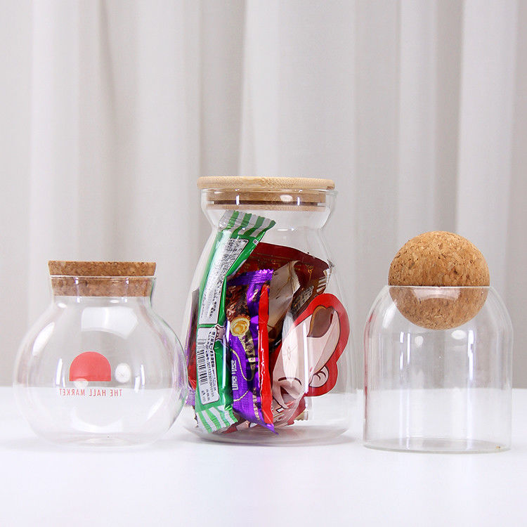Gran cantidad de diferentes tamaños de borosilicato de vidrio Jar de almacenamiento vacío de rosca de vidrio con tapa superior de rosca