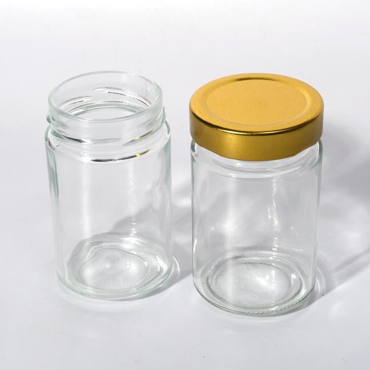 Uso de la fábrica de alimentos 1 oz 4 oz 8 oz Contenedor de almacenamiento vacío de forma redonda transparente Jarrón de salsa de miel de vidrio