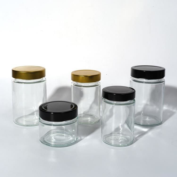 Uso de la fábrica de alimentos 1 oz 4 oz 8 oz Contenedor de almacenamiento vacío de forma redonda transparente Jarrón de salsa de miel de vidrio