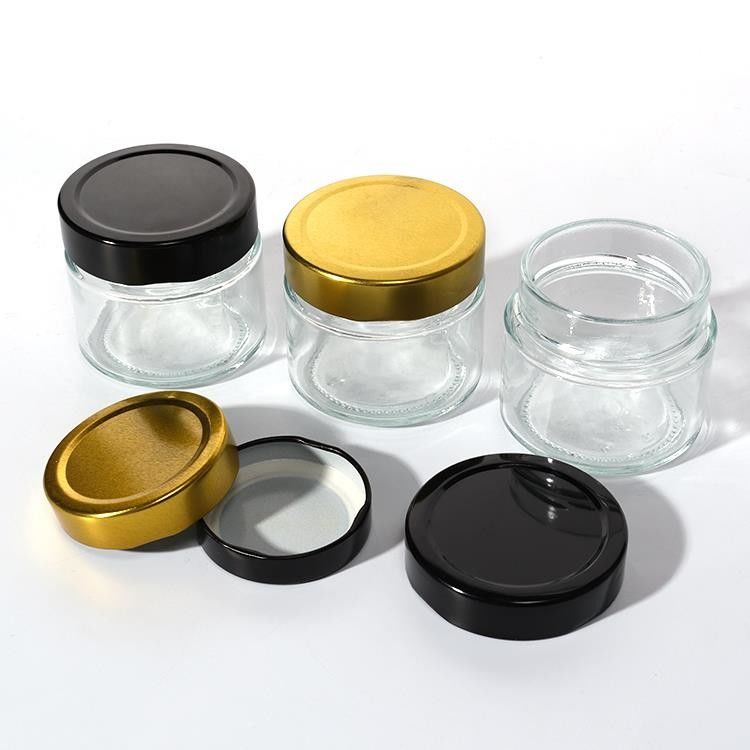 Uso de la fábrica de alimentos 1 oz 4 oz 8 oz Contenedor de almacenamiento vacío de forma redonda transparente Jarrón de salsa de miel de vidrio