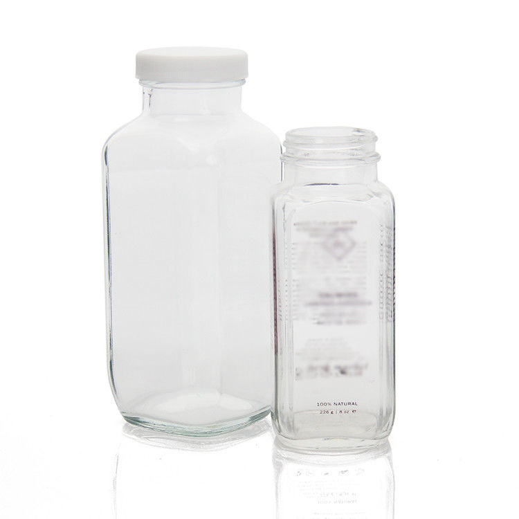 Botellas de jugo de vidrio cuadrada Botellas de jugo de vidrio con tapa a prueba de alteraciones para el embalaje de bebidas de jugo