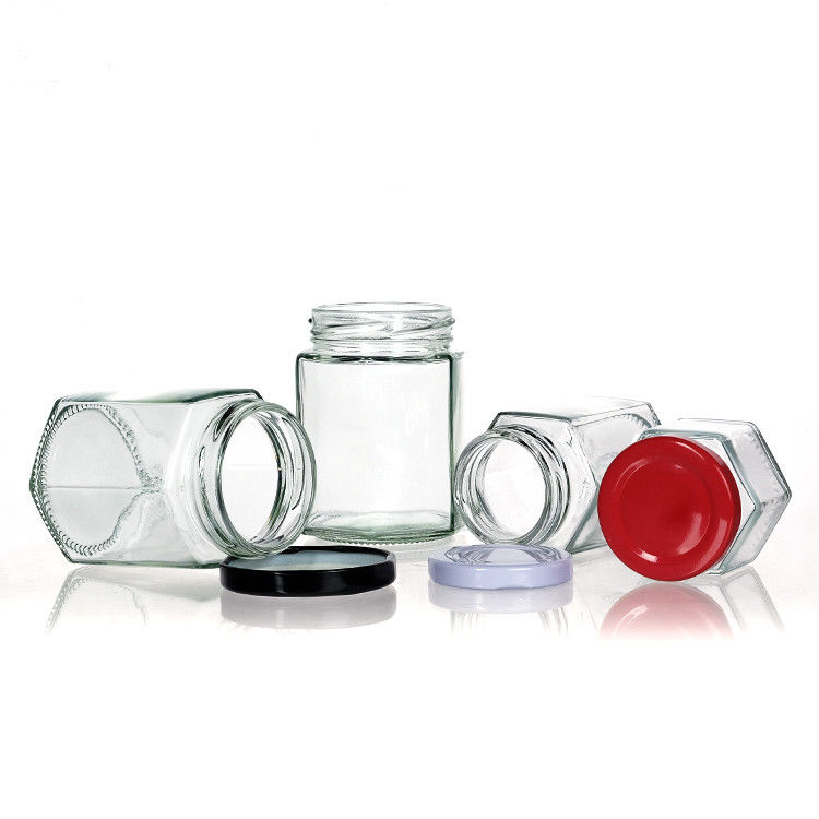 Jarrones de botellas transparentes con tapas Jarrón de almacenamiento de vidrio hexagonal para la lata de té