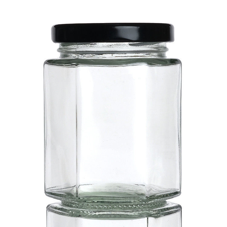 Jarrones de botellas transparentes con tapas Jarrón de almacenamiento de vidrio hexagonal para la lata de té