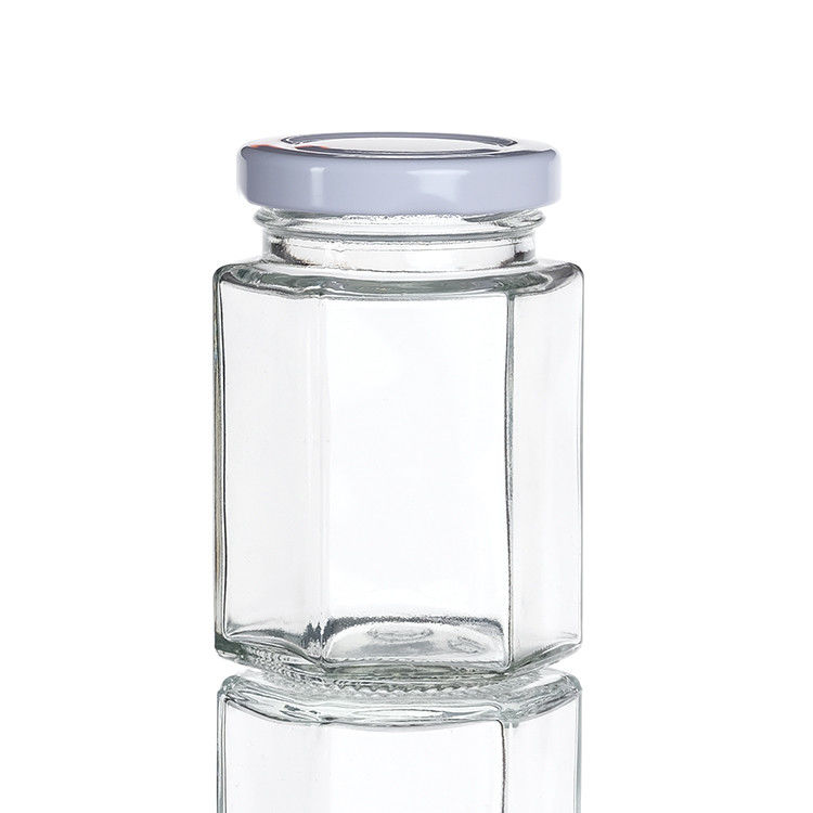 Jarrones de botellas transparentes con tapas Jarrón de almacenamiento de vidrio hexagonal para la lata de té